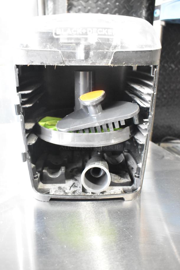Black & Decker food processor accessories in a hard case, includes multiple blades. Case shows wear; blades appear in fair condition.