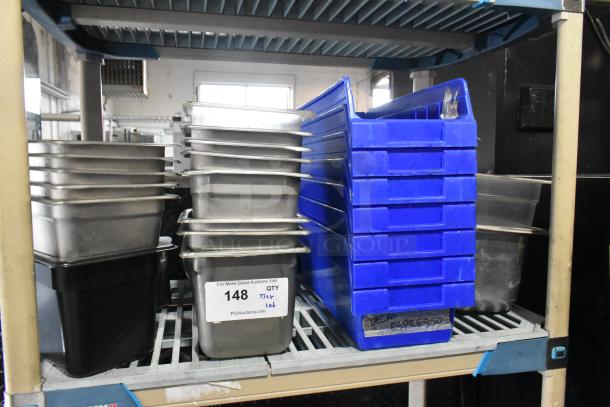 Tier lot of stainless steel drop-in bins and blue poly bins on a shelf. Tag reads "148, Qty Tier Lot, PCI Auctions."