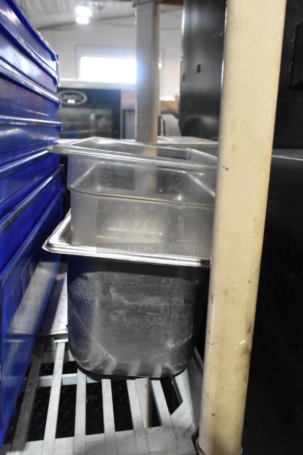 Assorted item lot including stainless steel and poly bins, shown on metal shelving; bins appear in used condition.