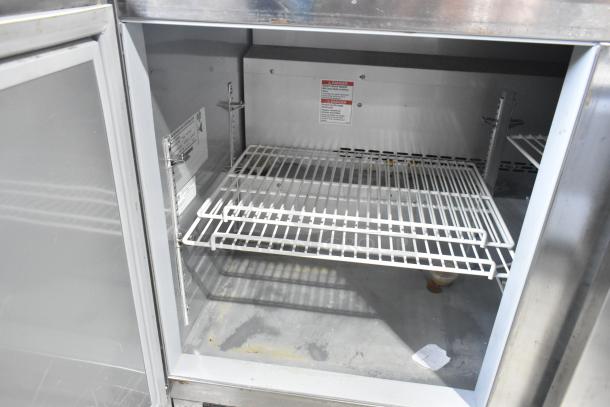Beverage Air UCR48AHC stainless steel 2-door undercounter cooler, interior view, showing adjustable shelves and power specs.