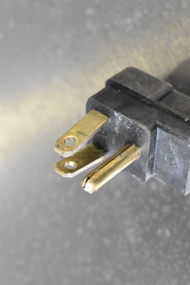 A close-up of a three-prong plug for the Beverage Air UCR48AHC undercounter cooler.