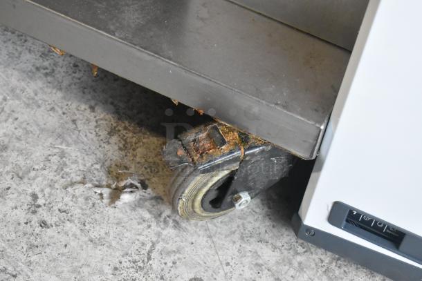 Fri-jado TDR 7-P stainless steel rotisserie oven caster shows signs of rust. Electric, 208V, 3 phase. Condition: used.