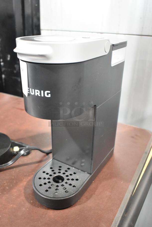 2024 Keurig Single Cup Coffee Machine, black, 120 volts, 1 phase, compact design, minimal wear, visible Keurig logo.