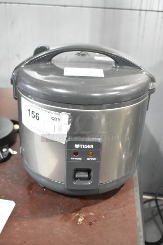 Tiger JNP-S10U Rice Cooker/Warmer, 120V, steel exterior, visible controls for cooking and warming. Auction label attached.