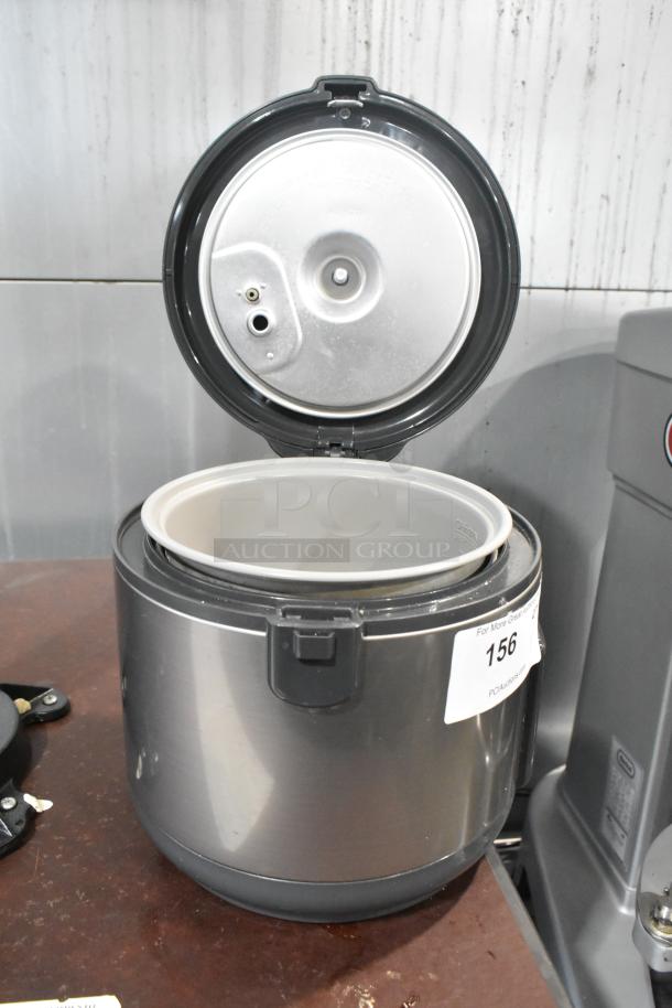Tiger JNP-S10U rice cooker/warmer, stainless steel finish, open lid showing inner pot, 120V, 1 phase, auction tag visible.