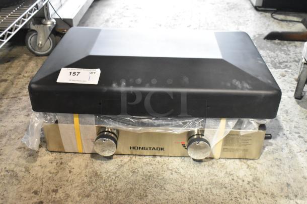 Hongtaok K23B Metal Propane Gas Flat Top Griddle, 21,000 BTU, features dual knobs, stainless steel body. Marked with item tag 157.