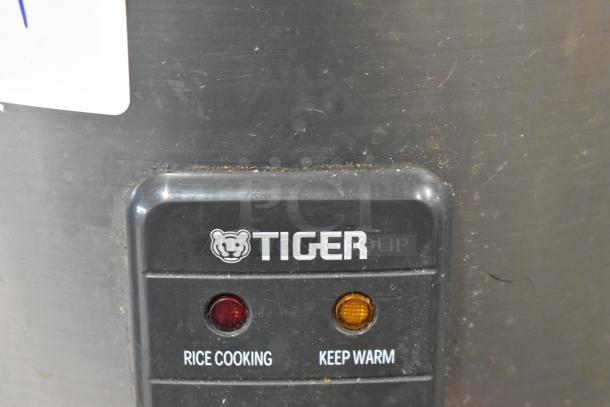 Tiger JNP-S18U Rice Cooker with warming function. Visible brand logo and indicator lights; condition shows slight wear.
