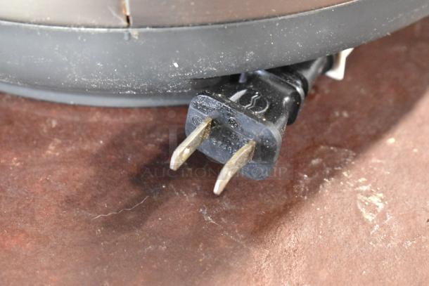 Power cord plug of Tiger JNP-S18U Rice Cooker/Warmer, 120 Volts, 1 Phase, showing signs of wear.