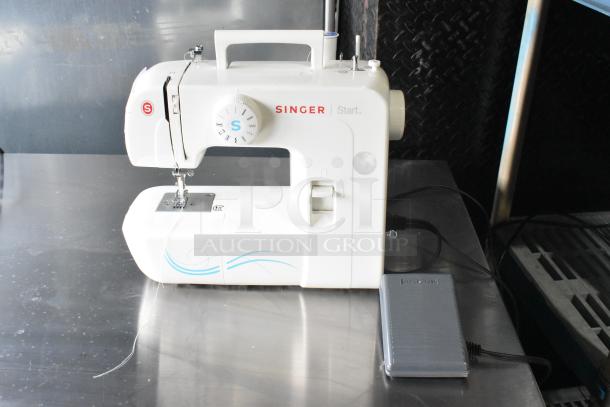 Singer countertop sewing machine with foot pedal. Features 120 volts, 1 phase. White color, slight wear visible.