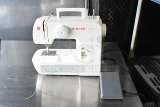 Singer countertop sewing machine with foot pedal. Features 120 volts, 1 phase. White color, slight wear visible.