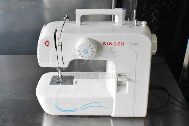 Singer countertop sewing machine with foot pedal, 120 volts, 1 phase, white, features stitch selector and carry handle.