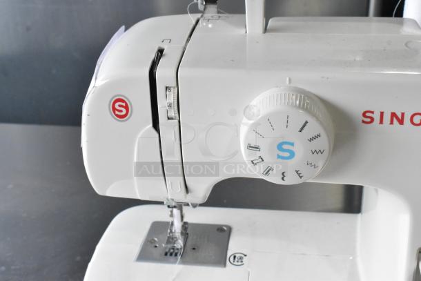 Singer countertop sewing machine with foot pedal; features multiple stitch settings, 120 volts, 1 phase.