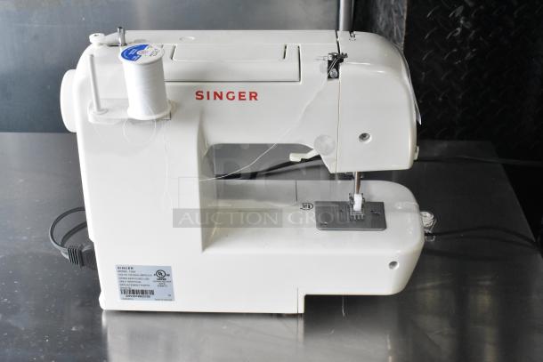Singer countertop sewing machine with foot pedal, 120 volts, 1 phase. Features include bobbin winder and spool pin.