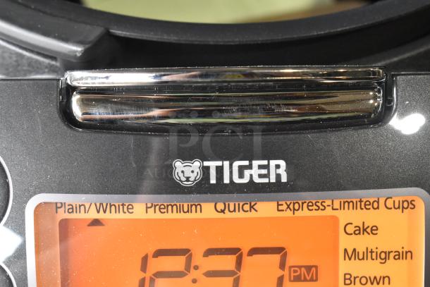 Tiger JKT-D18U rice cooker/warmer, black, digital display shows various settings. Lid does not close. 120V, 1 phase.