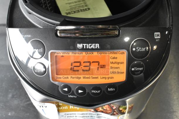 Tiger JKT-D18U rice cooker/warmer. Lid does not close. Features multiple cooking modes. 120 volts, 1 phase.