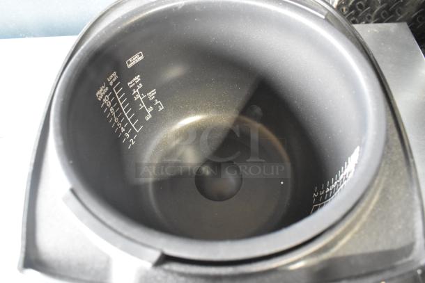 Tiger JKT-D18U rice cooker interior with measurement markings; lid does not close, 120V, countertop model.