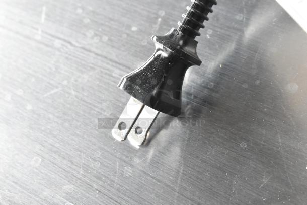 Close-up of a power plug for the Tiger JKT-D18U rice cooker. Note: Lid does not close. 120 volts, 1 phase.