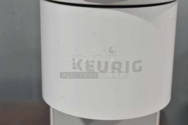 2024 Keurig Single Cup Coffee Maker, white. Features 120 volts, 1 phase, sleek design, and Keurig logo.