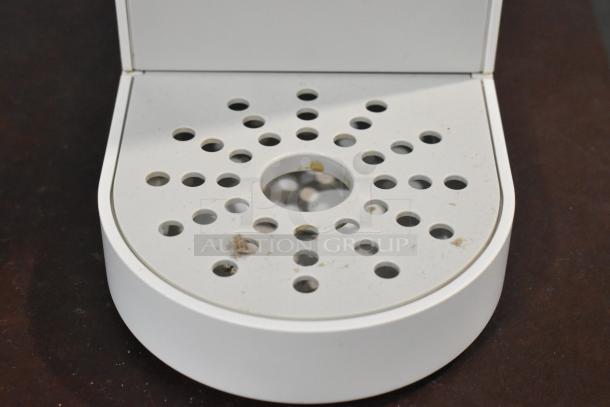 2024 Keurig single-cup coffee maker drip tray, white, showing signs of wear and minor stains.