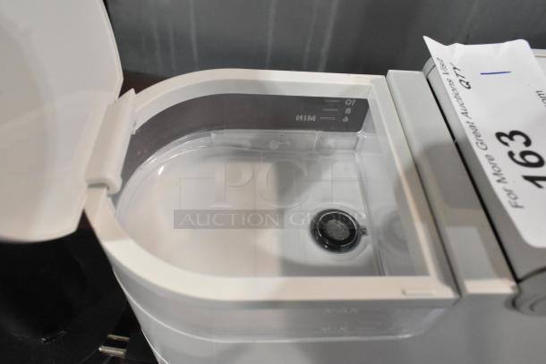 2024 Keurig Single Cup Coffee Maker showing open water reservoir with minimum and maximum fill indicators.