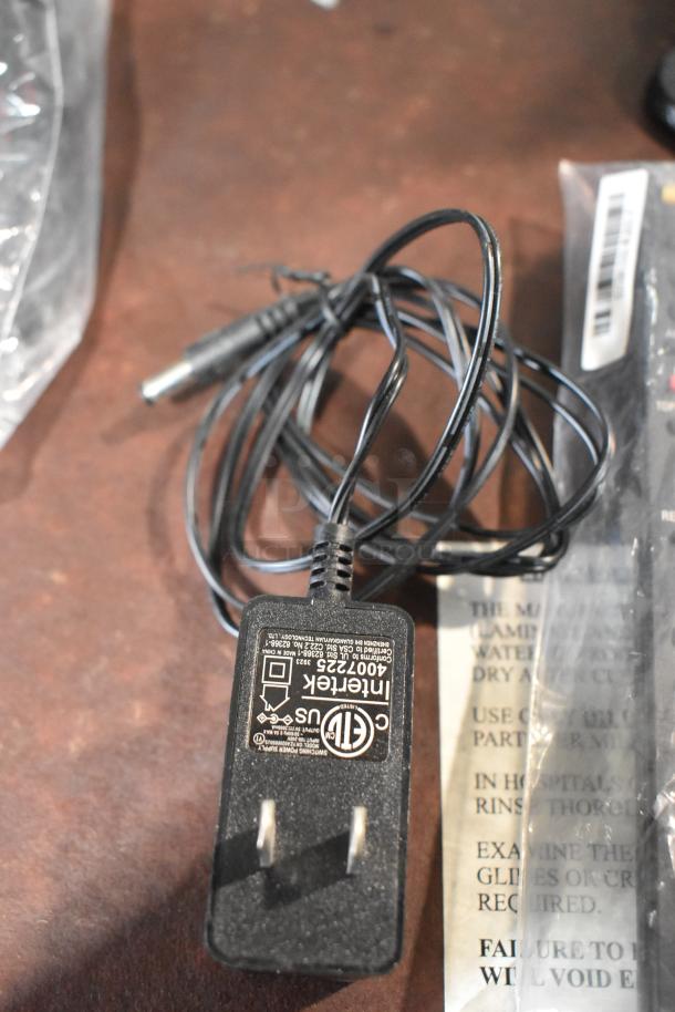 Close-up of a power adapter with labeling for the Sony BDP-S560 Blu-Ray Disc DVD Player, showing certification marks.