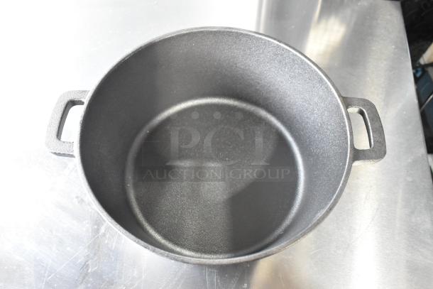Cast iron pot with dual handles, excellent condition, suitable for robust cooking and even heat distribution.