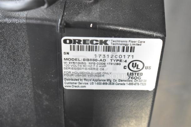 Oreck XL BB880-AD Vacuum Cleaner label, 120 volts, 1 phase, UL Listed, model and serial details visible.