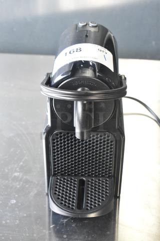 Nespresso SA countertop single cup coffee/espresso machine, 120 volts, Model SA, black finish, with visible item tag.