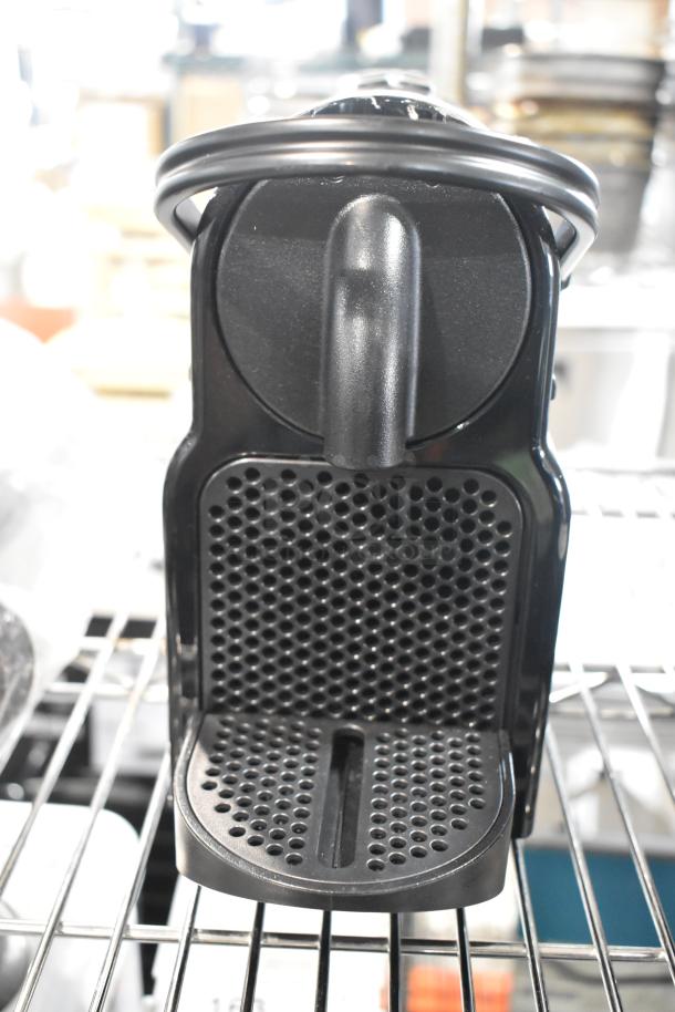 Nespresso SA countertop single cup coffee/espresso machine, 120 volts, sleek black design, used condition.