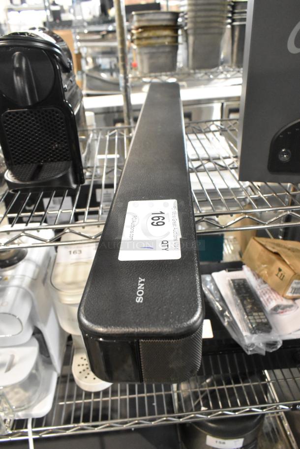 Sony HT-S100F Sound Bar in good condition, visible brand label. Features include 120 Volts, 1 Phase power. Auction tag present.