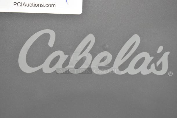 Cabela's gray metal safe, no keys included, logo visible on surface.