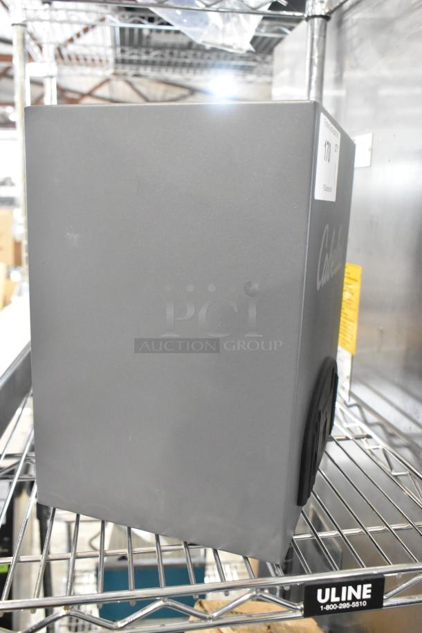 Cabela's gray metal safe on a shelf, missing keys. Slight scratches visible. Cabela's logo on the side.