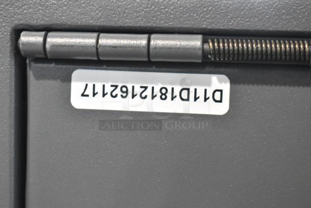 Cabela's gray metal safe with visible hinges and label. No keys included. Model number D111812162177.