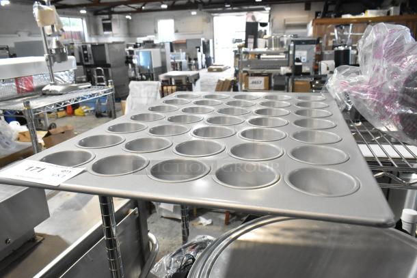 Lot of metal items including a muffin baking pan with multiple cups, in good condition. Auction tag labeled "177."