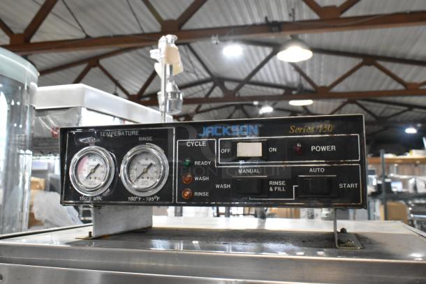 Jackson Series 150 commercial pass-through dishwasher control panel with temperature gauges and cycle settings.