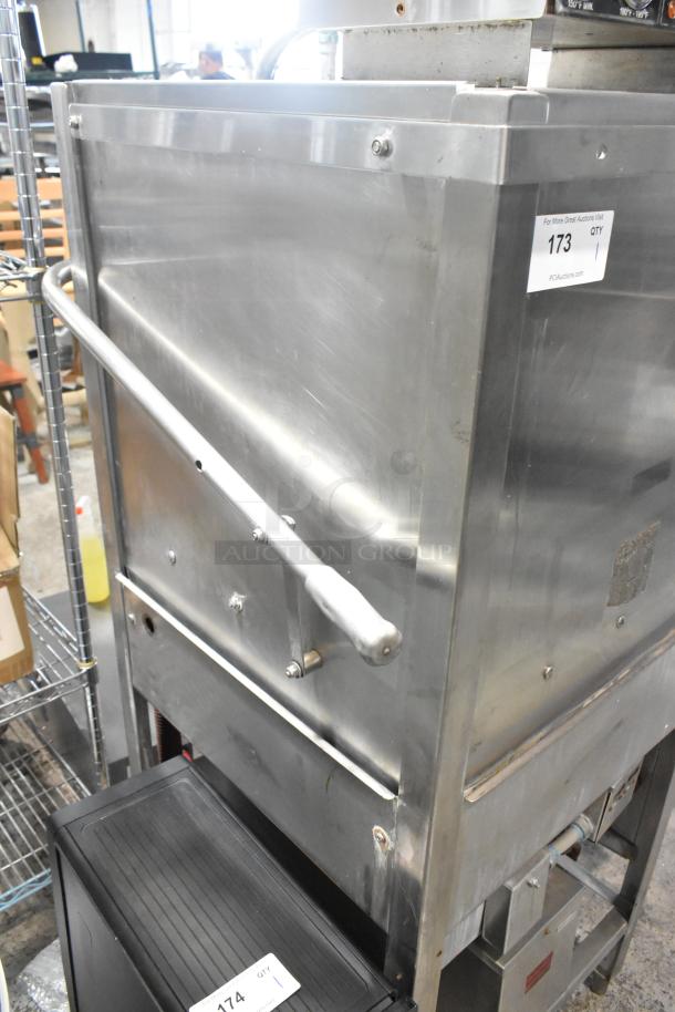 Jackson stainless steel commercial pass through dishwasher in good condition, featuring durable construction and visible auction tag.