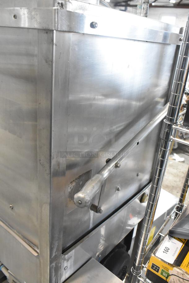 Jackson stainless steel commercial pass-through dishwasher, used, robust handle, slight surface wear.