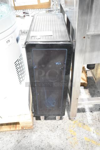 Black unit with sleek design, minor wear visible on the front panel. Features a top label; appears sturdy and functional.