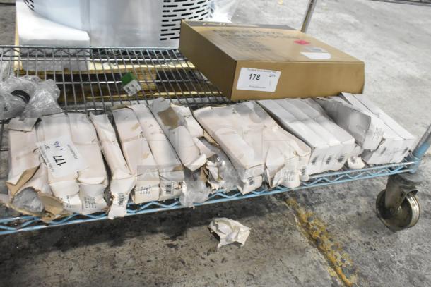 Boxes of 12 Walco Royal Bristol dessert spoons, 18/0 stainless steel, heavy weight, scratch and dent condition, on a metal cart.