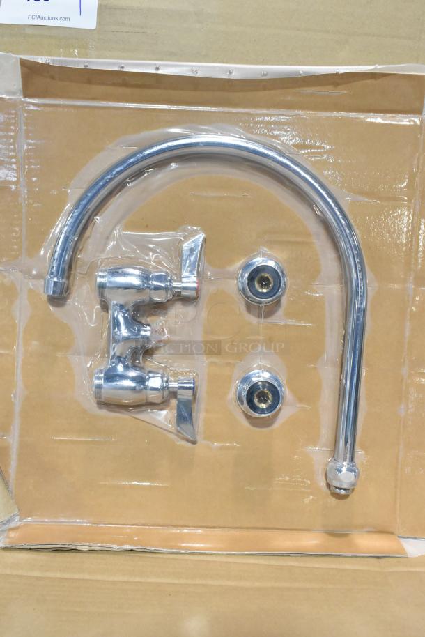 Brand new faucet with handles, chrome finish, slight scratches visible, packaged in cardboard and plastic wrapping.