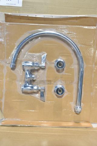 Brand new faucet with handles, chrome finish, slight scratches visible, packaged in cardboard and plastic wrapping.