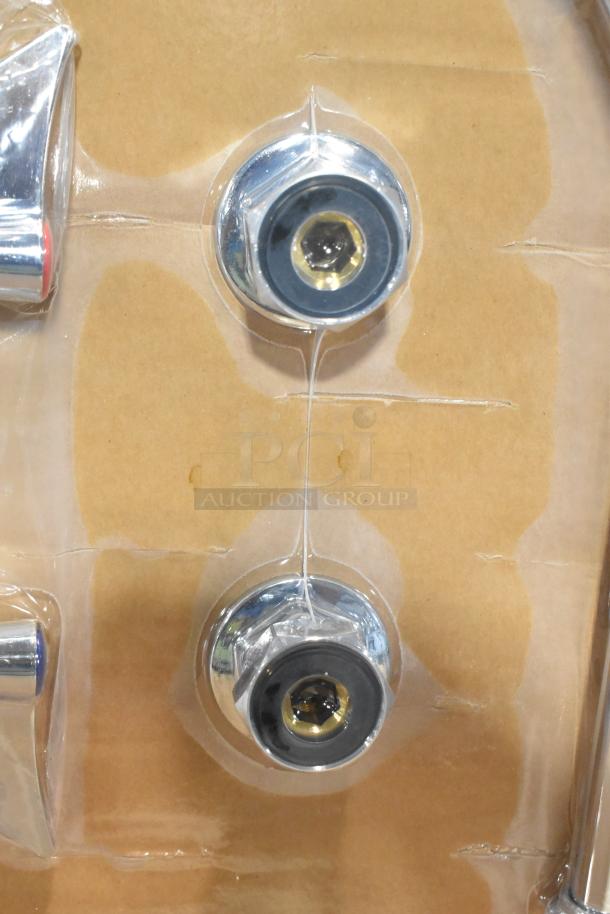 Brand new scratch and dent faucet with handles, chrome finish, visible packaging.