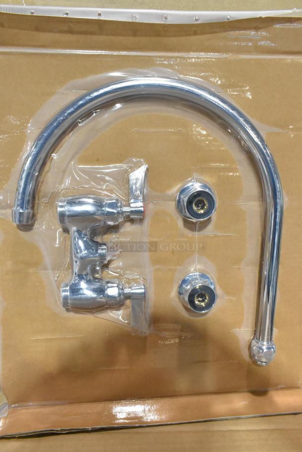 Brand new faucet with handles in packaging; chrome finish, minor scratches and dents, includes two handles and spout.