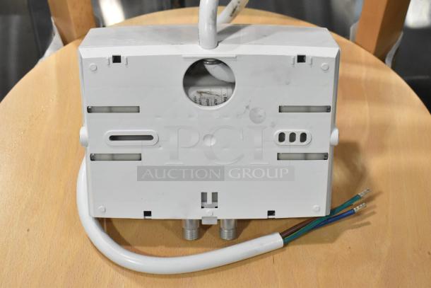 Stiebel Eltron Mini 3.5-1 tankless water heater, brand new with minor cosmetic dents, visible wires, and connection ports.