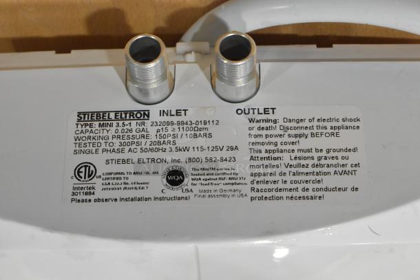 Brand new Stiebel Eltron Mini 3.5-1 tankless electric water heater. Visible label details model, capacity, and safety warnings.