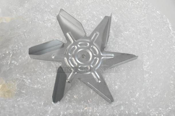 Brand new Blickman R61-120H3 fan motor on bubble wrap, showcasing a metallic six-blade design.