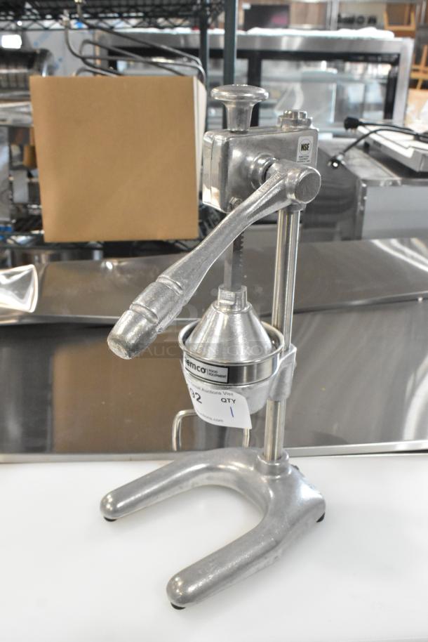 Brand new Nemco 55850 manual citrus juicer, heavy-duty metal, with minor scratches and dents; features a visible "NSE" label.