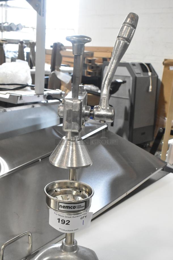 Brand new Nemco 55850 citrus juicer, manual heavy-duty, with minor scratches. Includes label indicating auction lot 192.