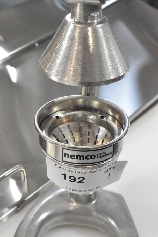 Brand new Nemco 55850 manual heavy-duty citrus juicer, stainless steel, scratch and dent condition, labeled "192" from auction.