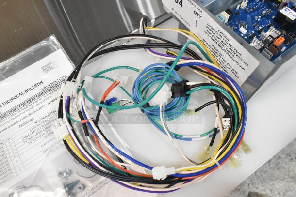 Brand new Traulsen control panel circuit board with multi-colored wires. Includes technical bulletin and assembly parts. Slight dents visible.